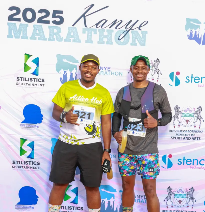 Two participants at the 2025 Kanye Marathon photo backdrop